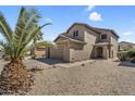 Charming two-story home featuring low-maintenance desert landscaping and an attached two-car garage at 1061 E Poncho Ln, San Tan Valley, AZ 85143