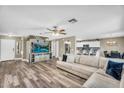 Spacious living room with modern wood flooring and an entertainment center, open to the kitchen at 1061 E Poncho Ln, San Tan Valley, AZ 85143