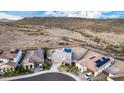 Aerial view of homes in a desert landscape, showcasing tiled roofs, solar panels, and spacious lots at 11366 W Ashby Dr, Peoria, AZ 85383