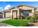 Charming single-story home with a well-manicured lawn and a two-car garage at 11366 W Ashby Dr, Peoria, AZ 85383