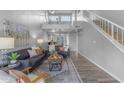 Bright living room featuring modern decor, comfortable seating, and staircase leading to the upper level at 14002 N 49Th Ave # 1029, Glendale, AZ 85306