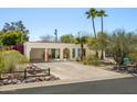 Inviting single-story home boasting a carport, desert landscaping, and palm trees for a serene setting at 1401 E Griswold Rd, Phoenix, AZ 85020