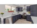 Modern kitchen features navy cabinets, stainless steel appliances, and a bright, inviting atmosphere at 1537 W Impala Ave, Mesa, AZ 85202