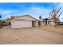 Charming single-story home featuring a low maintenance front yard, a two-car garage, and desert landscaping at 1627 E Saint Anne Ave, Phoenix, AZ 85042