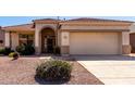 Attractive single-story house with a tile roof, arched entryway, and well-maintained desert landscaping at 17805 W Arizona Dr, Surprise, AZ 85374