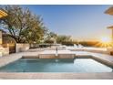 An oversized and luxurious swimming pool with in-pool loungers and views of the surrounding neighborhood at 19978 N 101St Pl, Scottsdale, AZ 85255