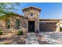 Charming stone facade and well-maintained landscaping enhance curb appeal of this house at 22214 E Cherrywood Dr, Queen Creek, AZ 85142