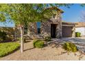 Attractive stone accents and landscaping create a warm, welcoming exterior at 22214 E Cherrywood Dr, Queen Creek, AZ 85142