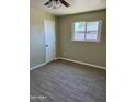 A well-lit bedroom with clean tile flooring and neutral-colored walls at 2801 W Camelback Rd, Phoenix, AZ 85017