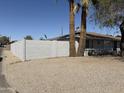 A gray stucco single-story home with minimal desert landscaping and a solid block privacy fence is shown at 3018 W Rancho Dr, Phoenix, AZ 85017