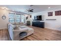 Bright living room featuring a large sectional sofa and modern entertainment center at 3507 E Jasper Dr, Gilbert, AZ 85296