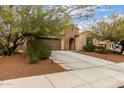 Inviting single-Gathering home with a two-car garage, stone accents, and a well-maintained desert landscape in the front yard at 3718 W Bingham Dr, New River, AZ 85087