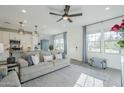 Inviting living room featuring a ceiling fan, natural light, and seamless flow into the dining and kitchen areas at 4077 S Sabrina Dr # 138, Chandler, AZ 85248