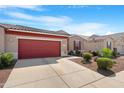 Well-kept single-story home with a two-car garage, desert landscaping, and concrete driveway at 41615 W Caliente Dr, Maricopa, AZ 85138