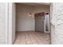 Charming entry featuring terracotta tile, neutral walls, and gray front door with holiday decor at 4721 W Eva St, Glendale, AZ 85302