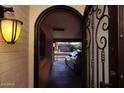 View of the home's entryway, featuring a security door and a covered parking area at 5301 W Vernon Ave, Phoenix, AZ 85035