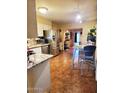 Functional kitchen featuring stainless steel appliances, a dining table, and view into the home at 5301 W Vernon Ave, Phoenix, AZ 85035