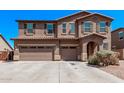 Beautiful two-story home with desert landscaping, a three-car garage and a neutral exterior at 6755 S Tucana Ln, Gilbert, AZ 85298