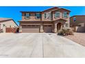 Charming two-story house with desert landscaping, a three-car garage and a welcoming entrance at 6755 S Tucana Ln, Gilbert, AZ 85298