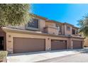 Desert townhome with two-car garage, neutral stucco, and desert landscaping at 705 W Queen Creek Rd # 1154, Chandler, AZ 85248