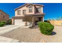 Inviting two-story home with a spacious driveway and xeriscaped front yard at 7274 W Alta Vista Rd, Laveen, AZ 85339