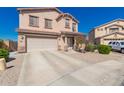 Two-story home featuring a two-car garage, desert landscaping, and well-maintained lawn at 7274 W Alta Vista Rd, Laveen, AZ 85339