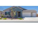 Charming single-story home with a three-car garage, desert landscaping, and a modern exterior paint scheme at 8025 W Gardenia Ave, Glendale, AZ 85303