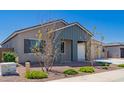 Charming single-story home with a two-car garage, desert landscaping, and a modern exterior paint scheme at 8025 W Gardenia Ave, Glendale, AZ 85303