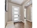 Bright foyer with tiled floors, a white front door, and a comfortable bench at 8857 S 167Th Ln, Goodyear, AZ 85338