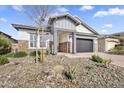 Beautiful single-story home with a stone and stucco exterior and desert-style landscaping at 8857 S 167Th Ln, Goodyear, AZ 85338