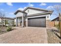 Attractive single-story home featuring a brick driveway and stone accents on the exterior at 8857 S 167Th Ln, Goodyear, AZ 85338