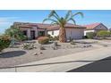 Beautiful single-story home with a landscaped front yard with native plants at 16017 W Wildflower Dr, Surprise, AZ 85374