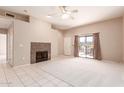 Spacious living room with fireplace and sliding doors to patio with outdoor seating at 16354 E Palisades Blvd # 3103, Fountain Hills, AZ 85268