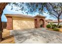 Spacious single-story home with a large driveway and desert landscaping at 17532 W Caribbean Ln, Surprise, AZ 85388