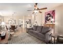 Open concept living room featuring a ceiling fan and views of the dining room at 17532 W Caribbean Ln, Surprise, AZ 85388