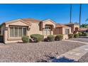 Inviting single-story home with decorative shutters and desert landscaping under a bright blue sky at 18254 N 136Th Ave, Sun City West, AZ 85375