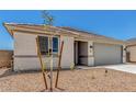 Single-story home featuring desert landscaping, concrete driveway, and neutral color palette at 18347 W Monte Lindo Ln, Surprise, AZ 85387