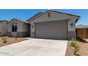 Lovely single-Gathering home boasts desert landscaping, a two-car garage, and a covered entryway at 18363 W Monte Lindo Ln, Surprise, AZ 85387
