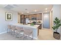 Bright kitchen with modern appliances, wooden cabinets, a large island with bar seating, and stylish decor at 2121 W Sonoran Desert Dr # 47, Phoenix, AZ 85085