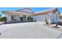 Inviting single-story home featuring a well-kept exterior, a spacious driveway, and desert landscaping at 2369 E Fiesta Dr, Casa Grande, AZ 85194