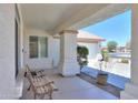 Covered front porch with classic bench, offering a relaxing entrance to this welcoming home at 2369 E Fiesta Dr, Casa Grande, AZ 85194