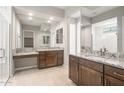 Elegant bathroom featuring granite countertops, double sinks, and large mirrors at 26650 W Siesta Ln, Buckeye, AZ 85396