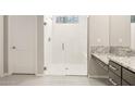 Modern shower with white subway tile, glass door, and rainfall shower head at 26650 W Siesta Ln, Buckeye, AZ 85396