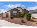 Single-story home with stone accents, a well-maintained front yard, and a gated side entrance at 36728 N Alderney Ct, San Tan Valley, AZ 85143