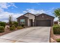 Beautiful home features a well-maintained front yard, gray color scheme, and attached two-car garage at 36728 N Alderney Ct, San Tan Valley, AZ 85143