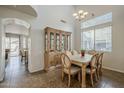 Dining room featuring tile floors, a large window, and a chandelier at 3816 E Phelps St, Gilbert, AZ 85295