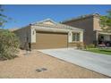 Side view of a single-story home with desert landscaping, a two-car garage, and a concrete driveway at 4582 E Jadeite Dr, San Tan Valley, AZ 85143