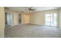 Spacious living room featuring neutral carpet, recessed lighting, and sliding glass doors to the backyard at 4582 E Jadeite Dr, San Tan Valley, AZ 85143