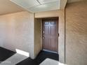 A close-up of the front door featuring a modern lock and security features, set in a textured alcove at 540 N May -- # 3131, Mesa, AZ 85201