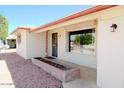 View of home entrance with mature shrubbery, decorative rocks, and red brick accents at 5533 E Decatur St, Mesa, AZ 85205